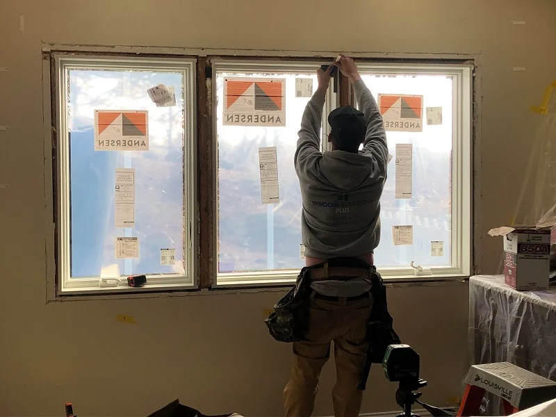 WIndow Solutions Plus master installer measuring for interior trim around Andersen 400 Series custom casement windows